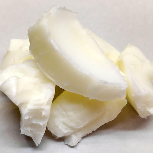 Close-up of a block of tallow on a white background
